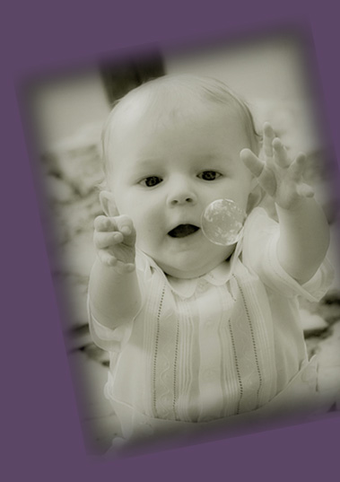 photo of a baby reaching for a bubble